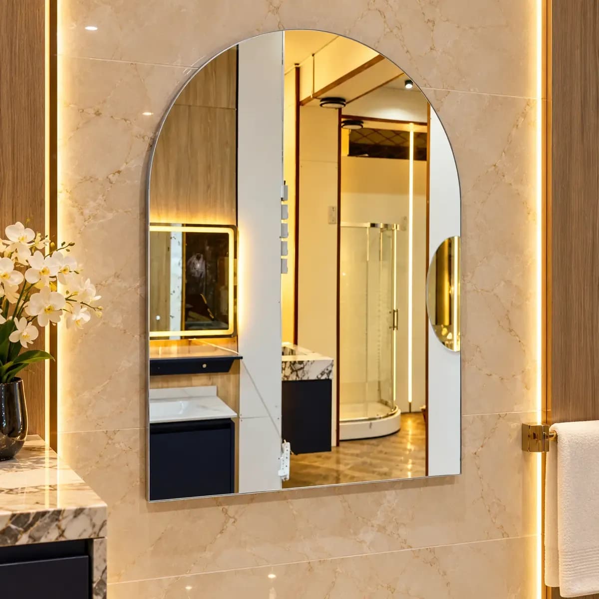Tall oval mirror with a narrow border, shown reflecting a styled bathroom scene.