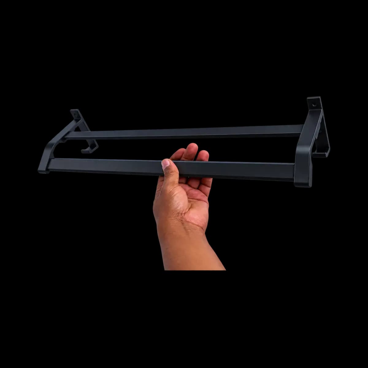 Black wall rail with two long horizontal bars and angular mounting brackets, shown held in a hand.