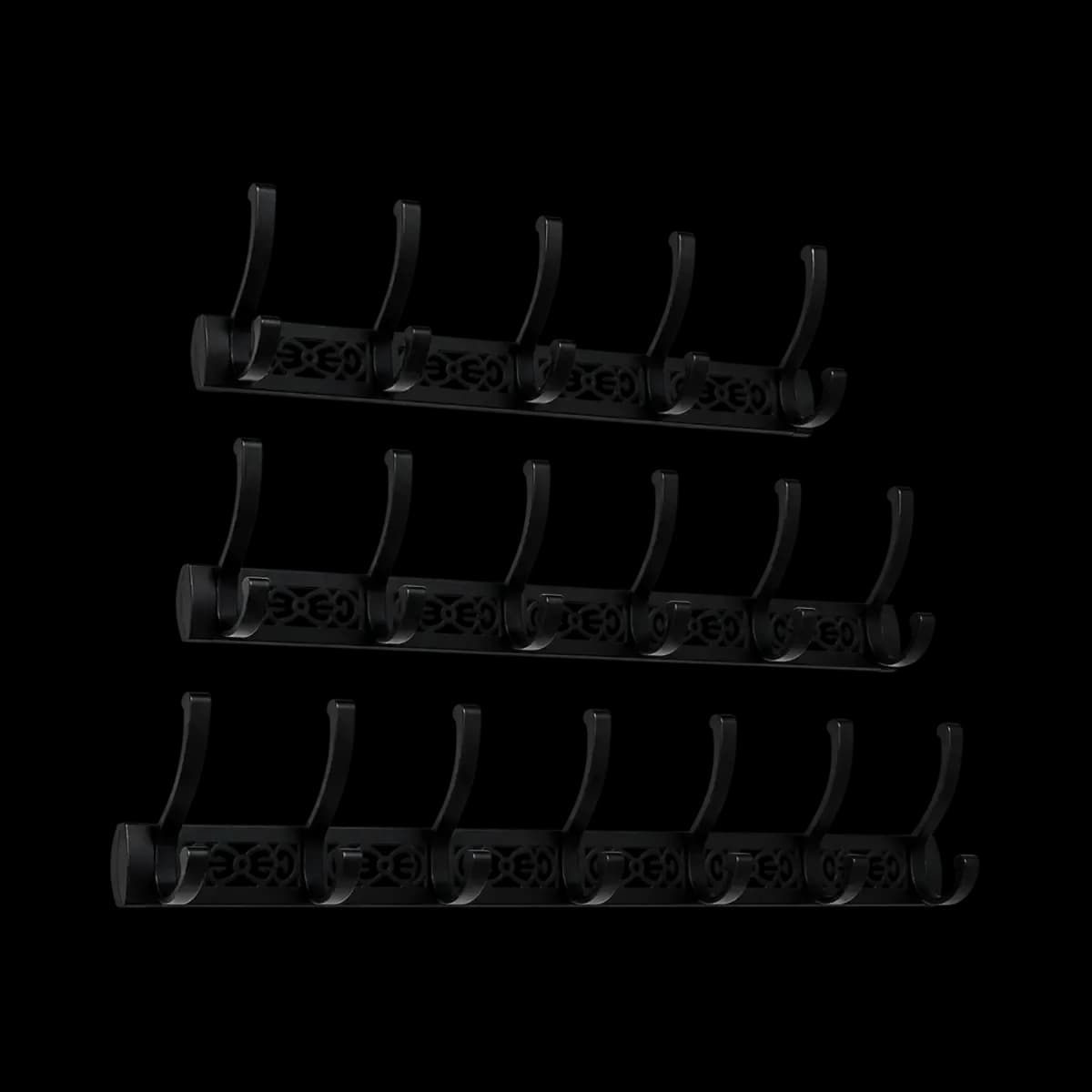 Three dark wall hook rails with decorative pale motifs and curved upper hooks.