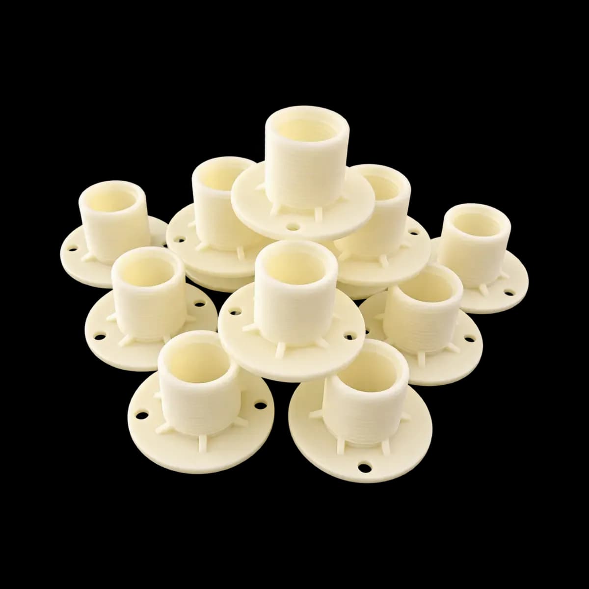 Several cream-coloured socket-style pipe fittings with round flanges and mounting holes.
