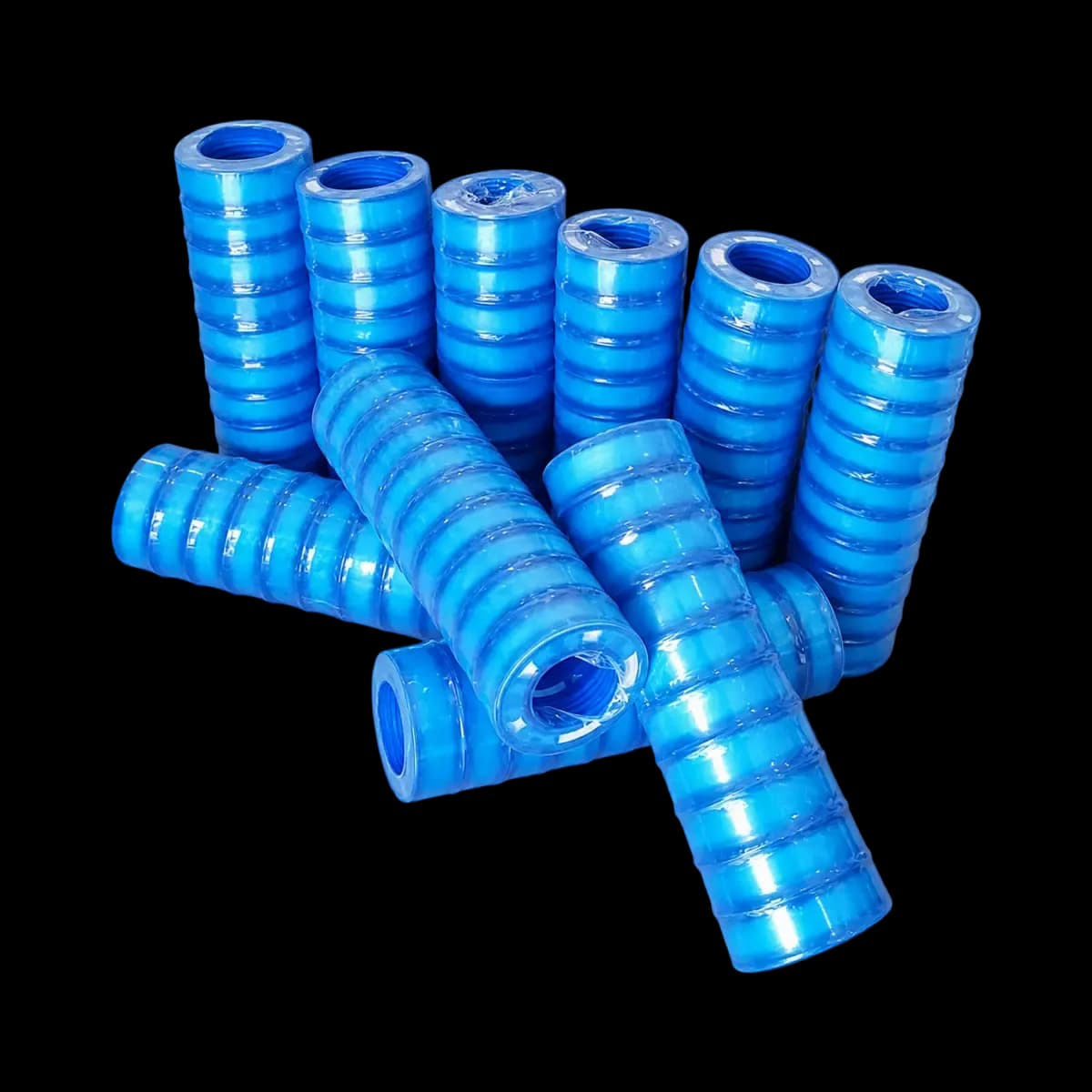 Multiple blue corrugated hose coils pictured in upright and horizontal arrangements.