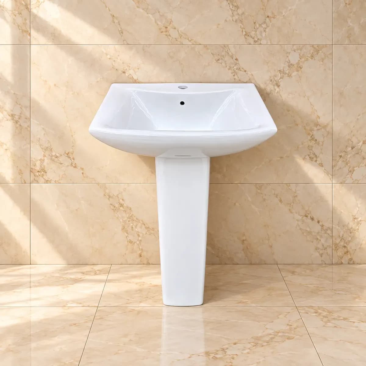 White basin with angular outer edges, a rounded inner bowl and tapering pedestal.
