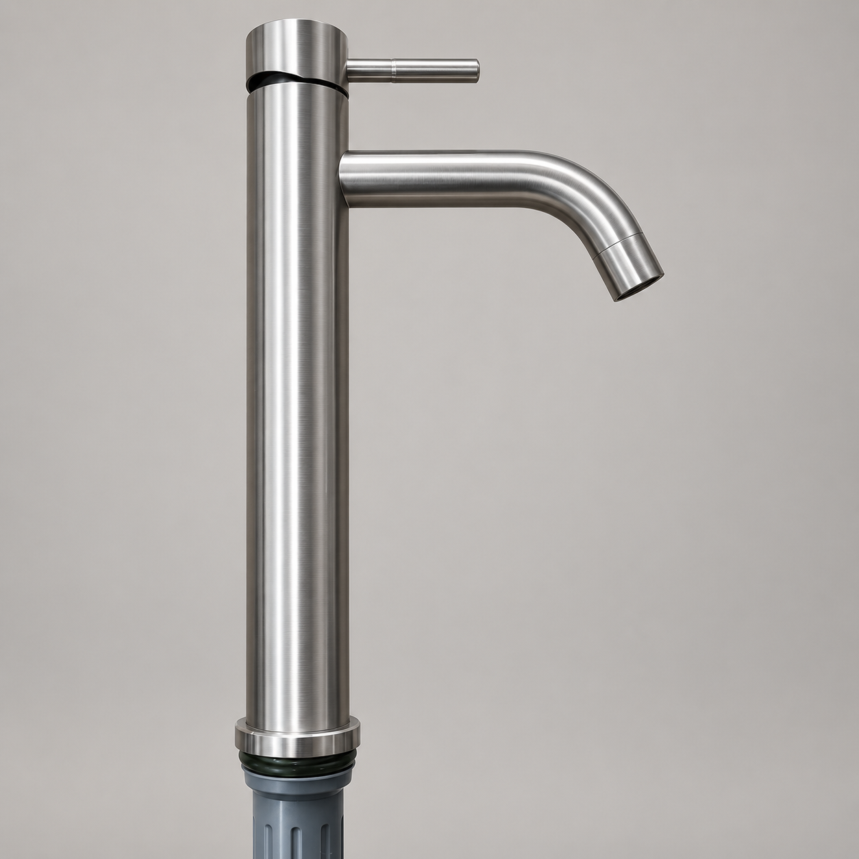 Tall brushed silver-grey basin tap with cylindrical stick lever and curved tubular spout